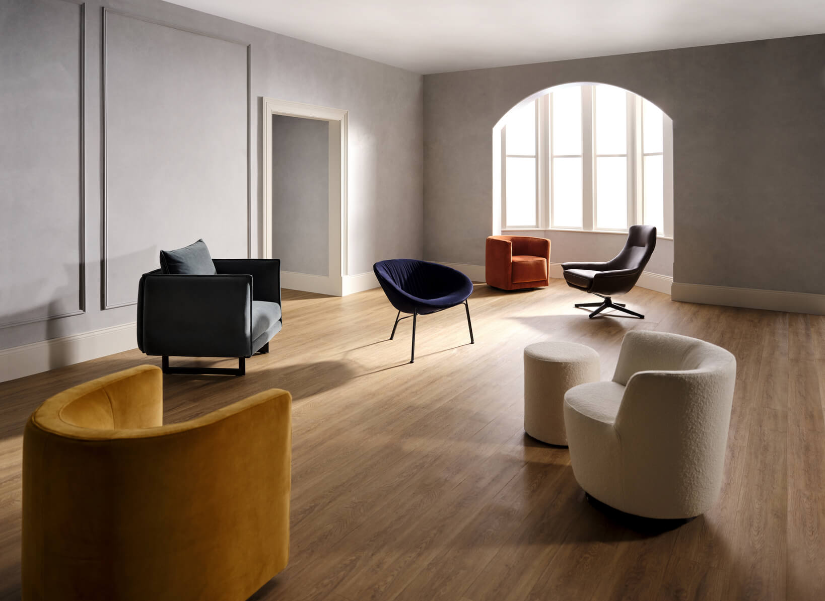 A studio shoot setting on six differently styled and coloured King Living reading chairs, all backed by the King Living 25 Year Steel Frame Warranty.