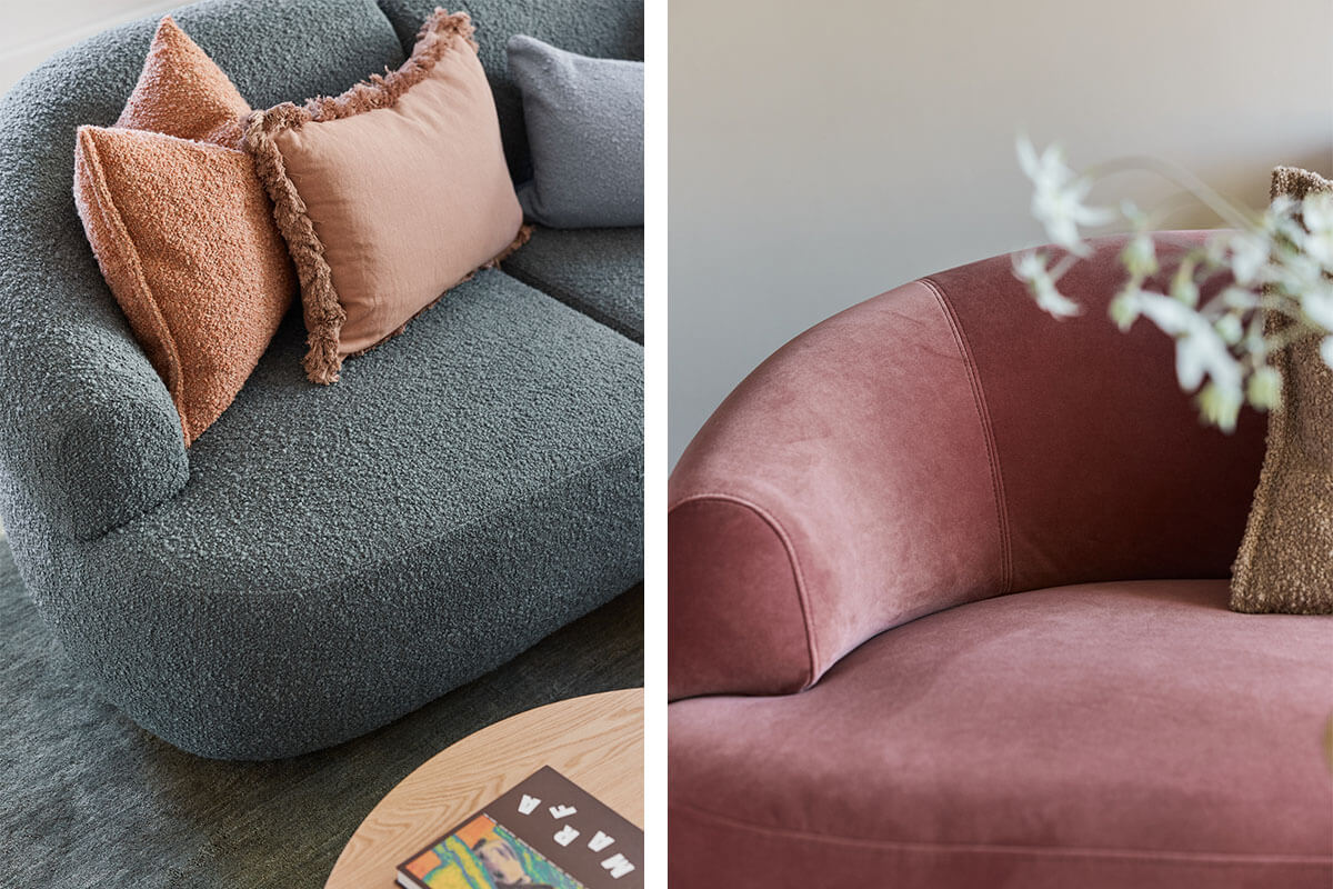 Woman sits on a salmon-coloured modular sofa that is curved and contemporary. Blue bouclé fabric and dusky pink velvet featured below.