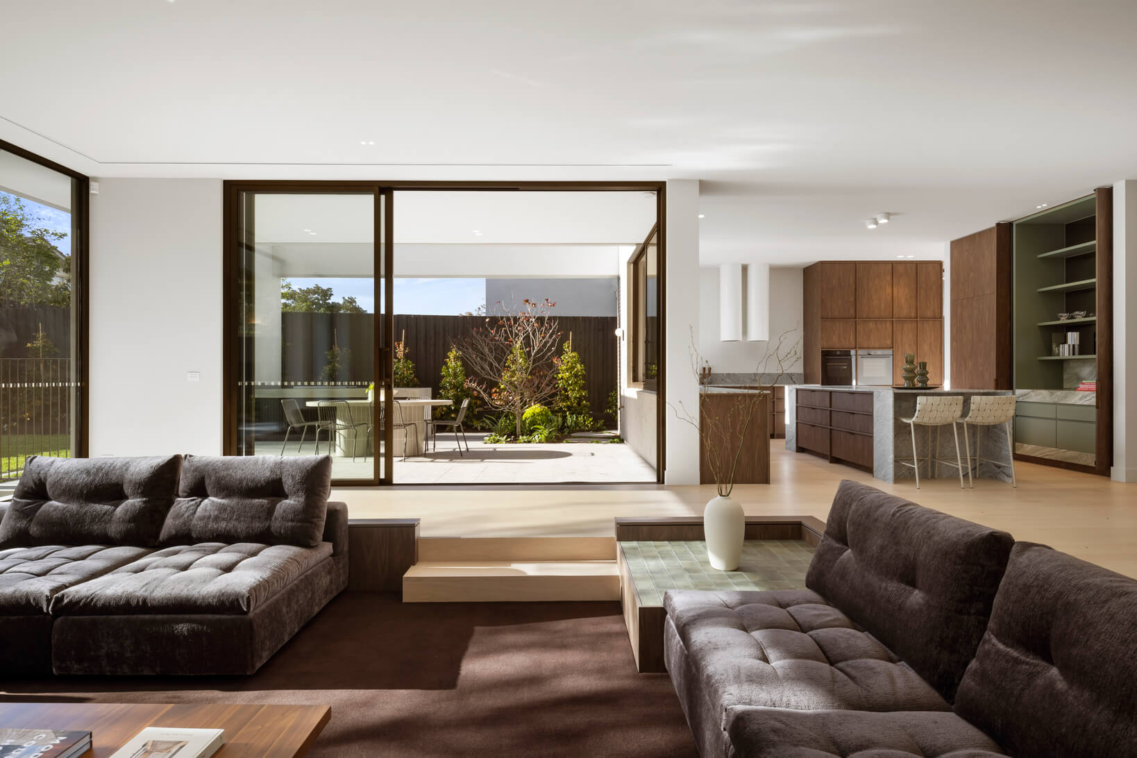 Expansive views to garden shot from interior, where connected living, dining and kitchen zones create movement and flow.