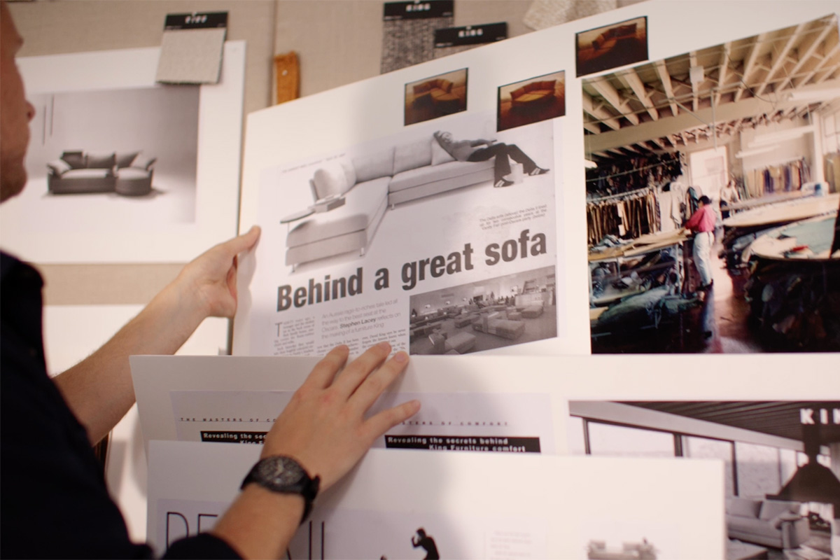 Mood board of newspaper articles collaged and pinned to studio wall.