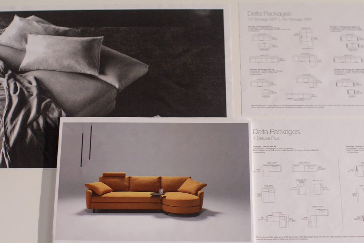 Curved sofa transformed into a supportive double bed, ideal for guests, with smart accessories like charging table and lamp.