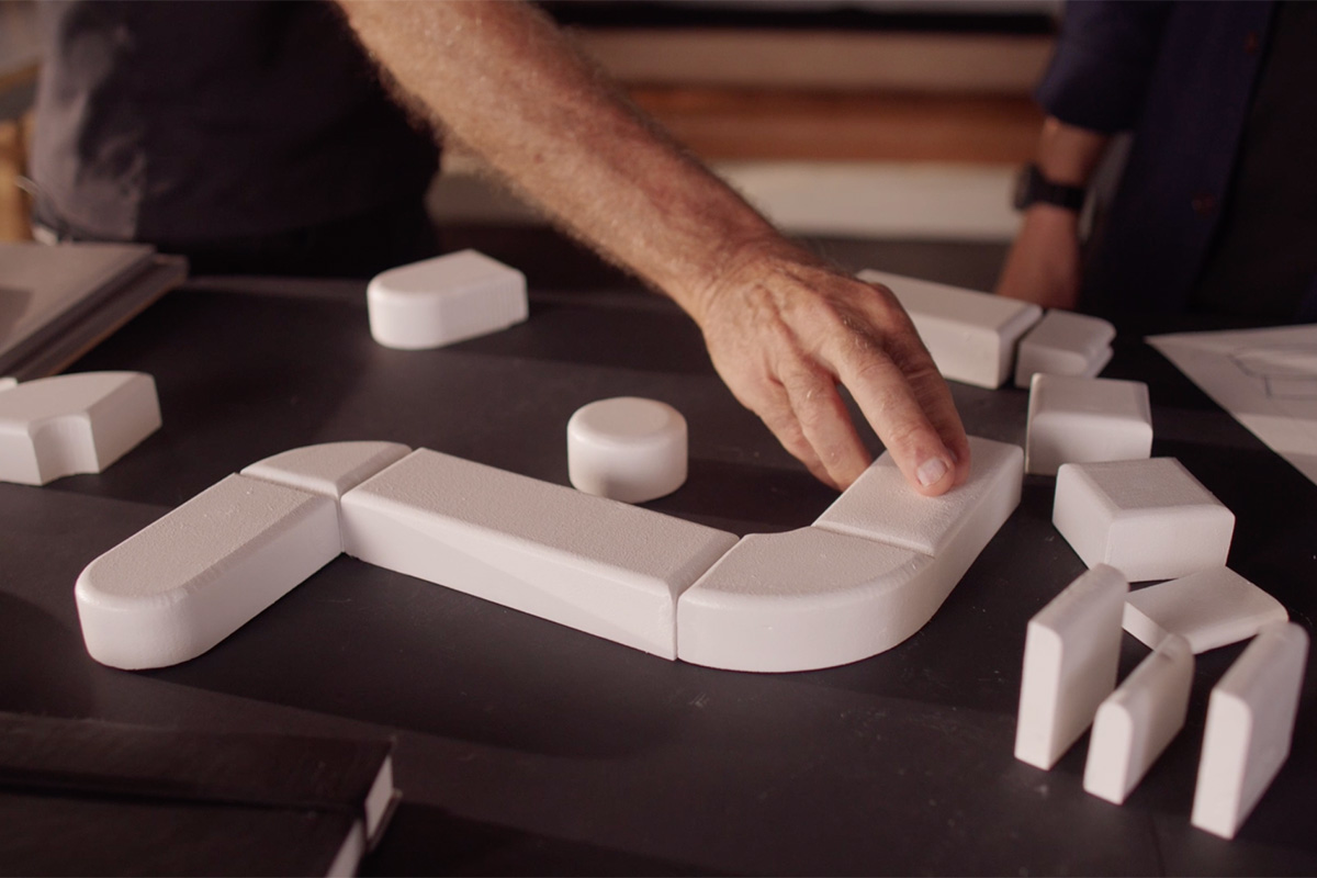 From foam prototype blocks on a table being reconfigured to the finished layout of the curved Delta 5 modular sofa.