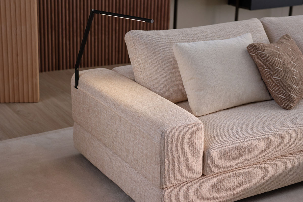 Modular sofa finished in a neutral cotton weave fabric styled with earthy-toned bouclé cushions.