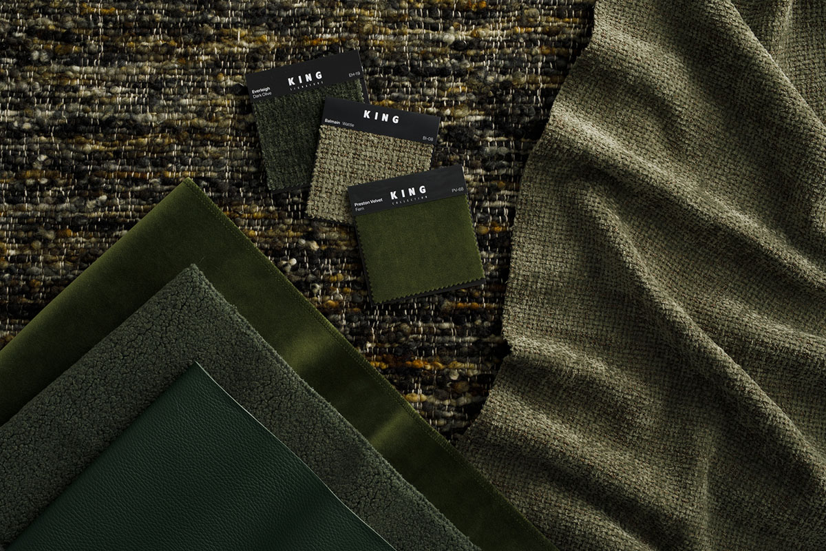 Modular outdoor sofa in green bouclé fabric. Flat lay of velvets and earthy leathers in forest and sage green tones.