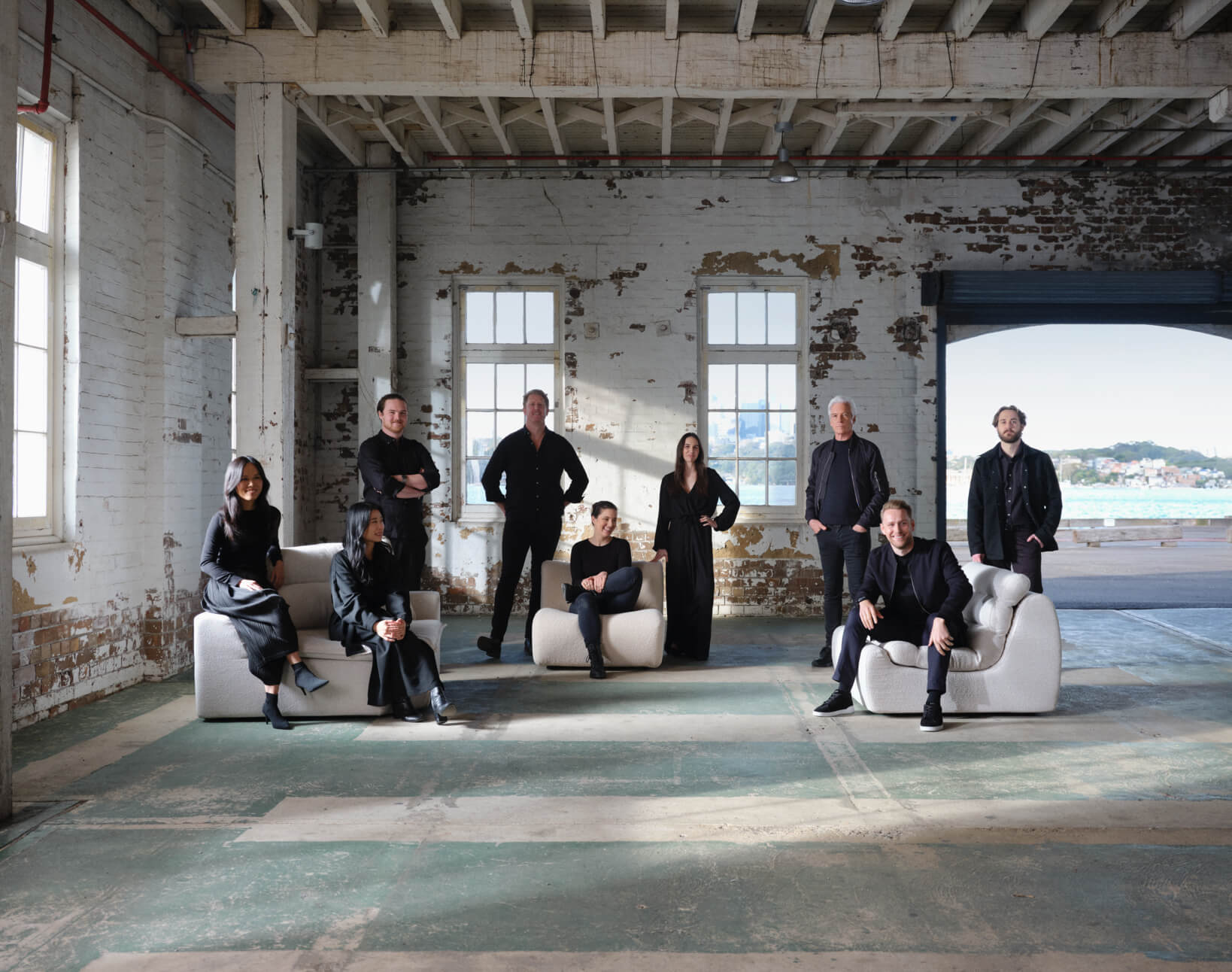 A cinematic shot of the King Living design team posed and dressed in black, shot on Cockatoo Island.