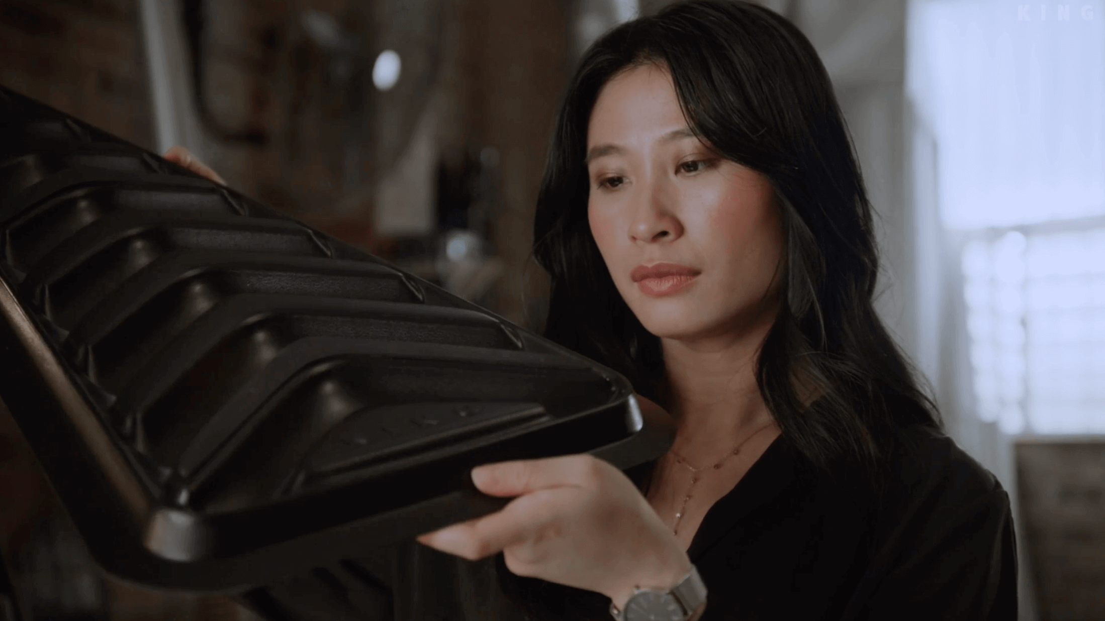 The sports shoe that inspired the FreeForm base above, with designer holding a prototype of the ridged base below.