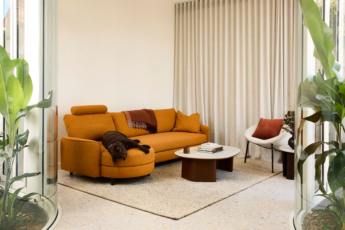 Two modern apartment properties with white modular sofas. Neutral styling with paneled timber walls and architectural beams.