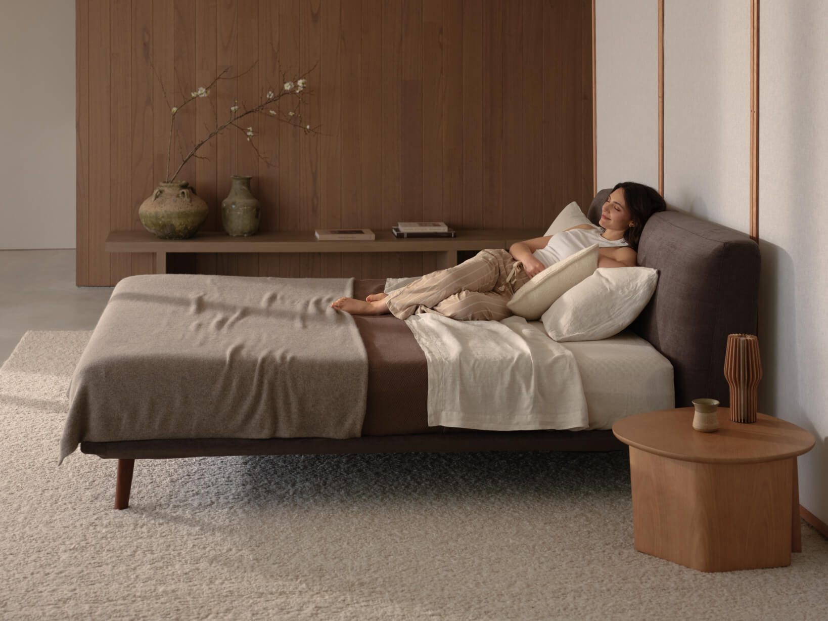Bedroom styled in mocha tones, linen and sand neutrals with timber furnishings and ceramic décor.