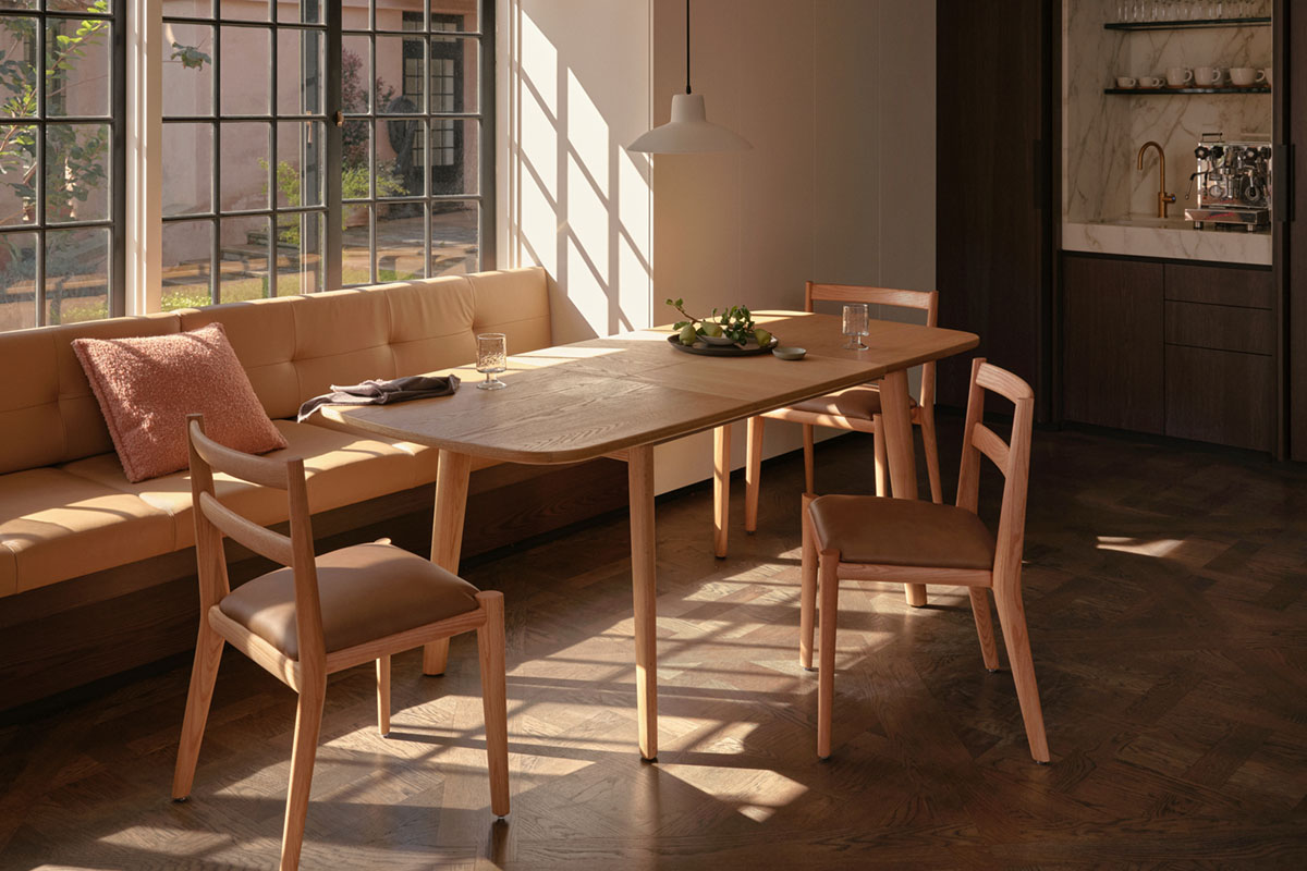 Small space kitchen-dining area styled with light timber dining chairs and a compact oval dining table.