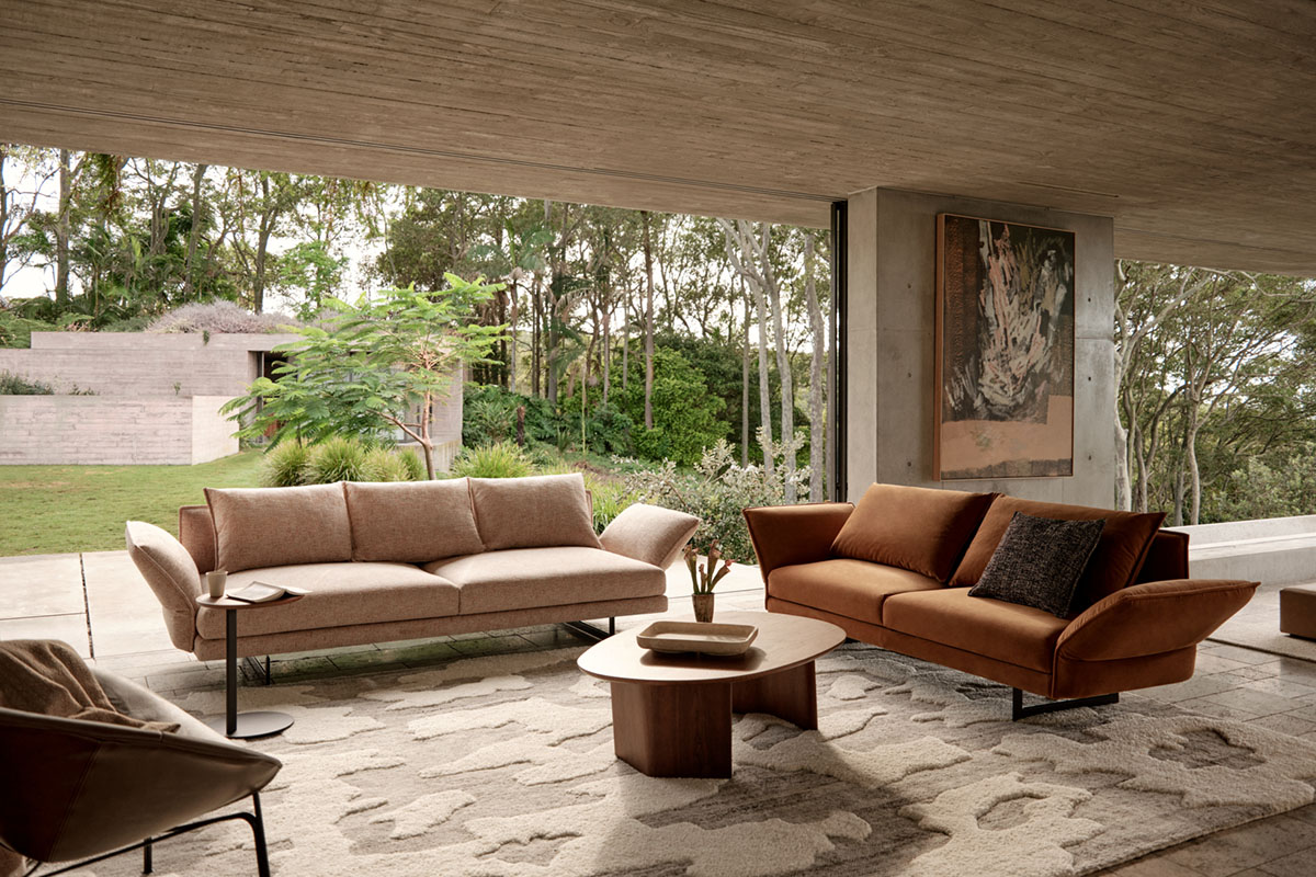 two sofas in an earthy living room with warm tones and garden views.