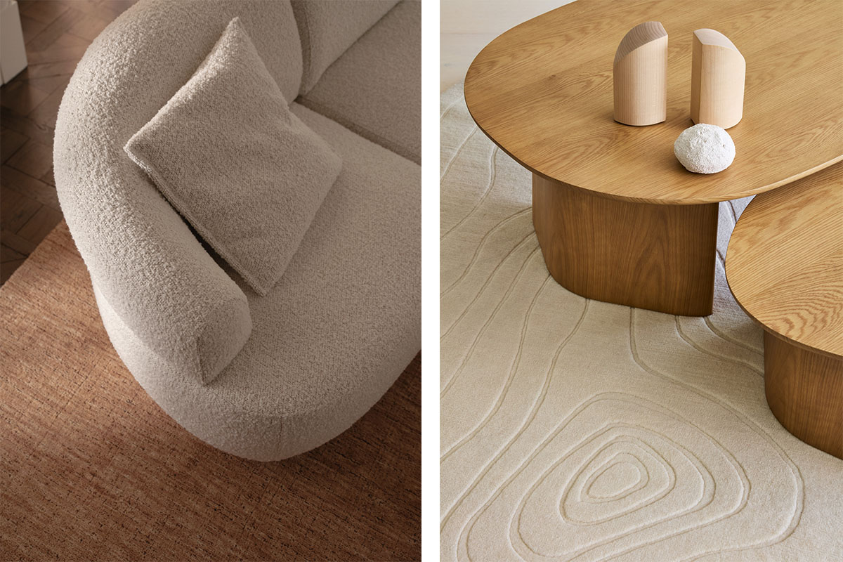 a curved modular sofa and layered coffee tables on contrasting tonal rugs.