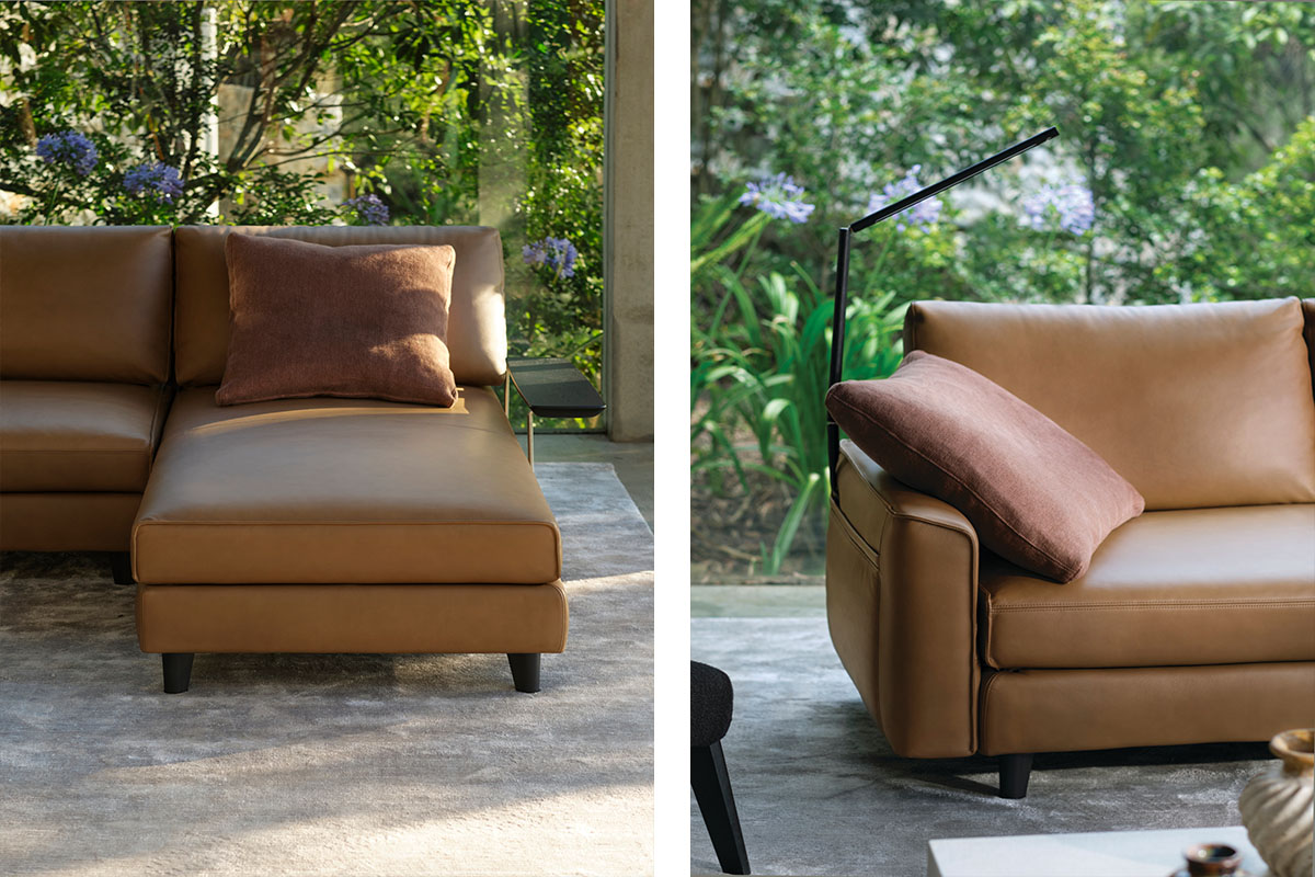 A modular sofa finished in a light warm caramel leather, pictured against lush greenery outdoors.