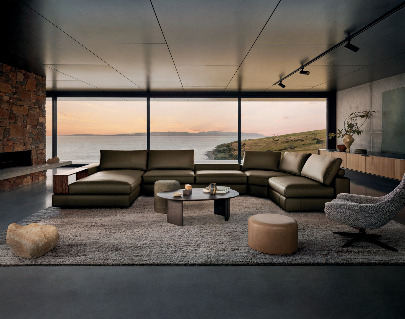 Dark olive green leather showcased on a large U-shape modular curved sofa.