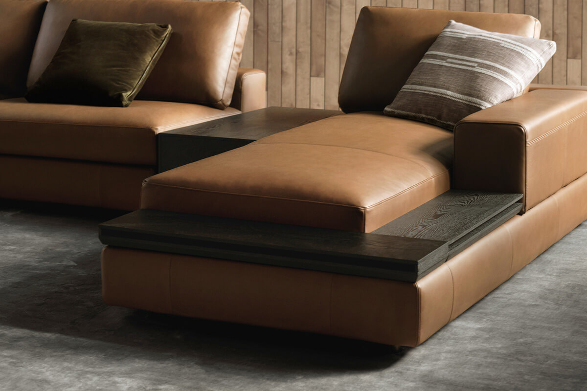 L-shape modular sofa with chaise styled in a warm brown leather.