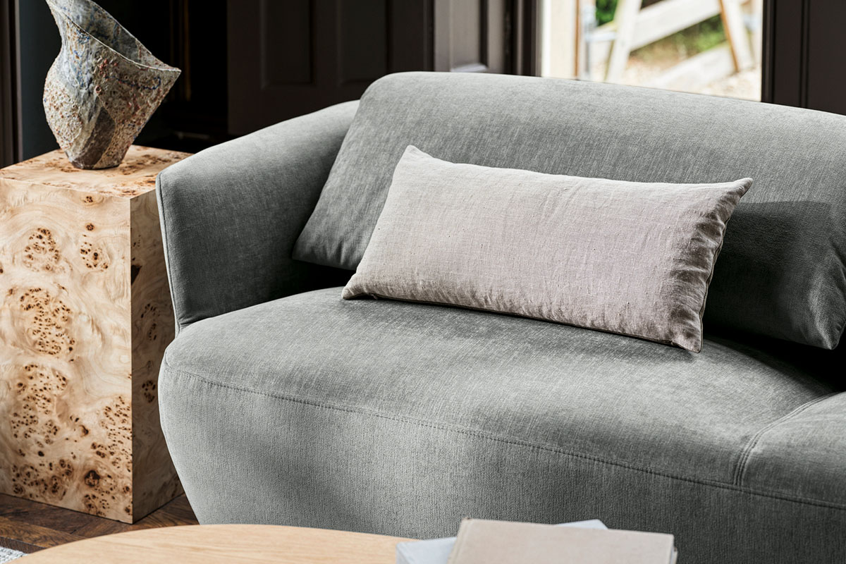 A fabric spotlight on Richmond with flat lays showcasing shade range and finished in a pale sage green on the Fleur Sofa.