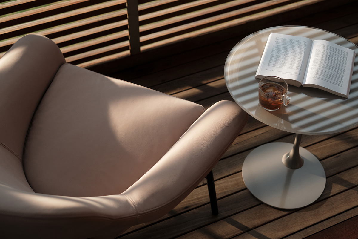 A leather armchair in a light-toned pink leather styled in a contemporary blush guest bedroom.