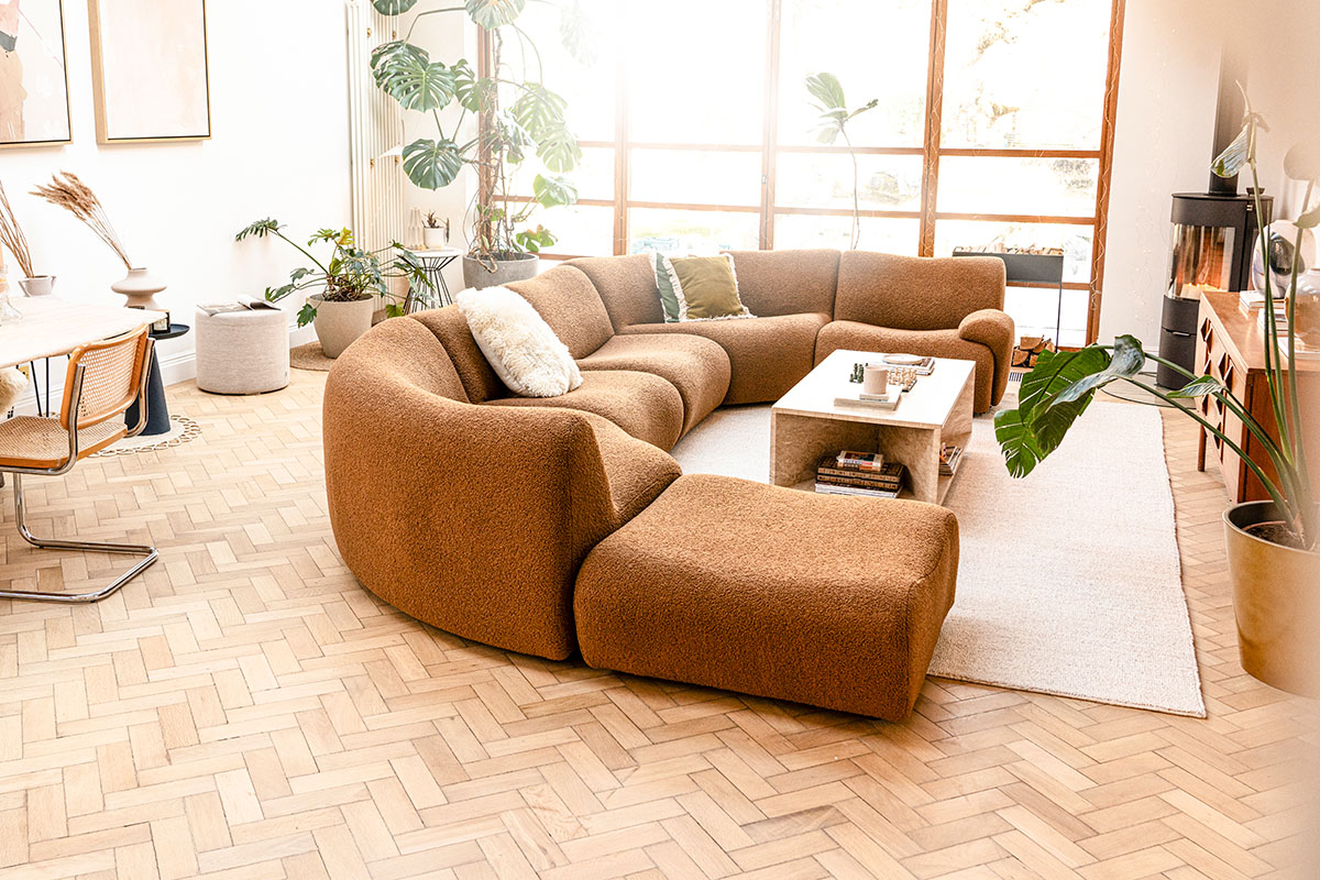 A refined open-plan living space bathed in natural light, seamlessly connected to the dining and kitchen areas.