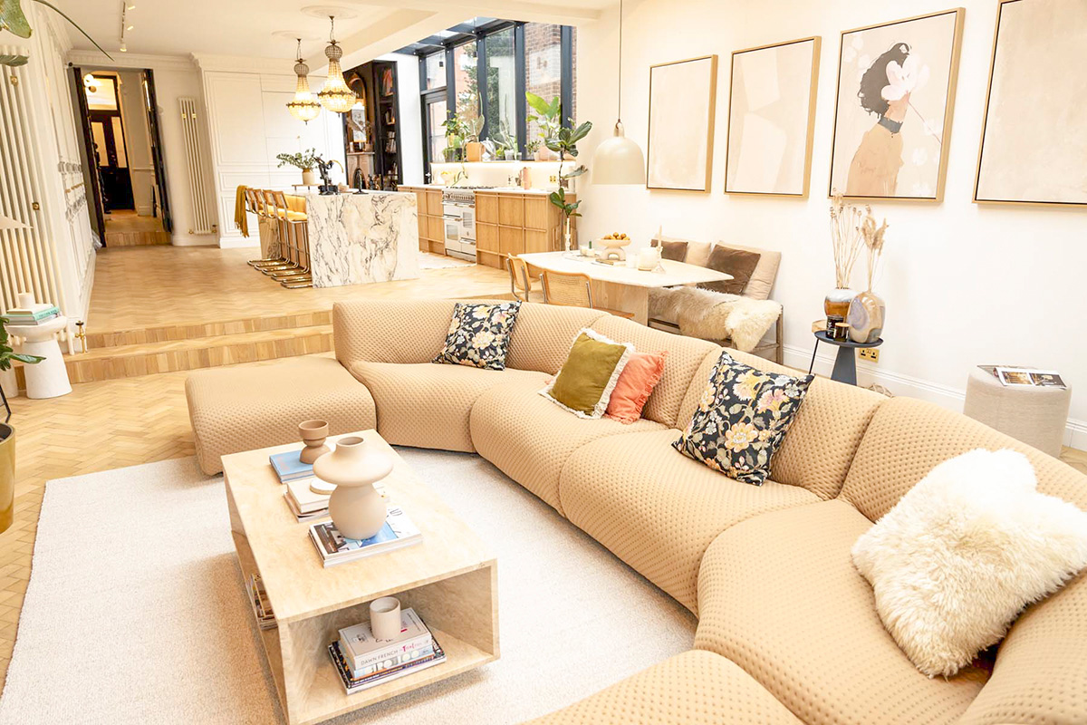 A refined open-plan living space bathed in natural light, seamlessly connected to the dining and kitchen areas.