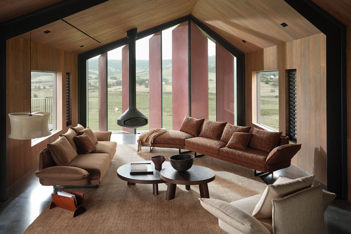 Rust woven sofas in a timber living room with views (above). Close-up rust patterned fabric and matching sofa (below).