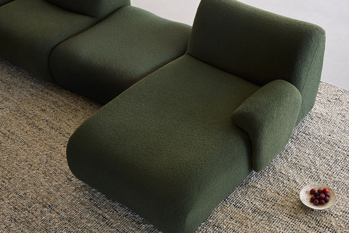 Close up of a green sofa with a clean timeless shape