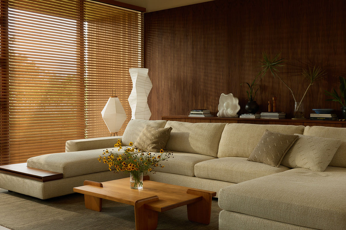 Olive holding her baby in soft light, and a serene living room with a neutral modular sofa and timber coffee table.