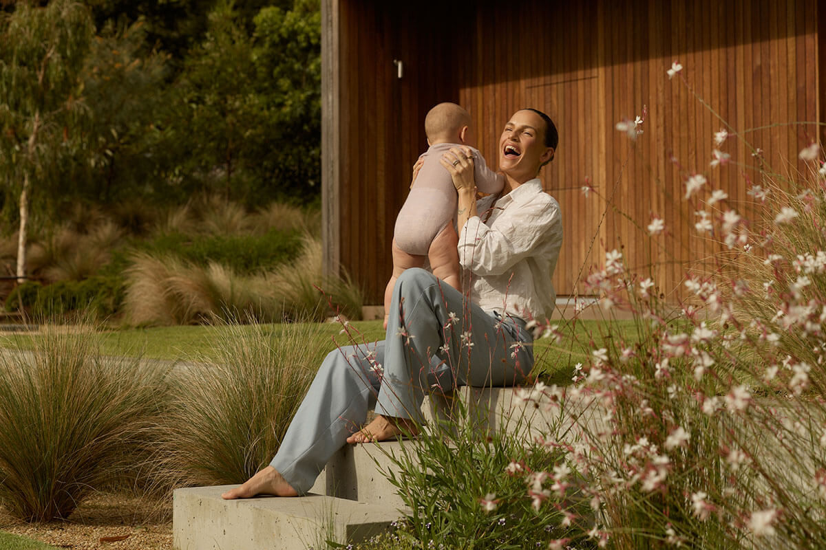 Exterior and interior shots of Australian country home and furnishings crafted from timber materials in warm tones.